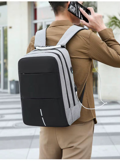 Person wearing a black and gray backpack with earphones, walking outdoors.