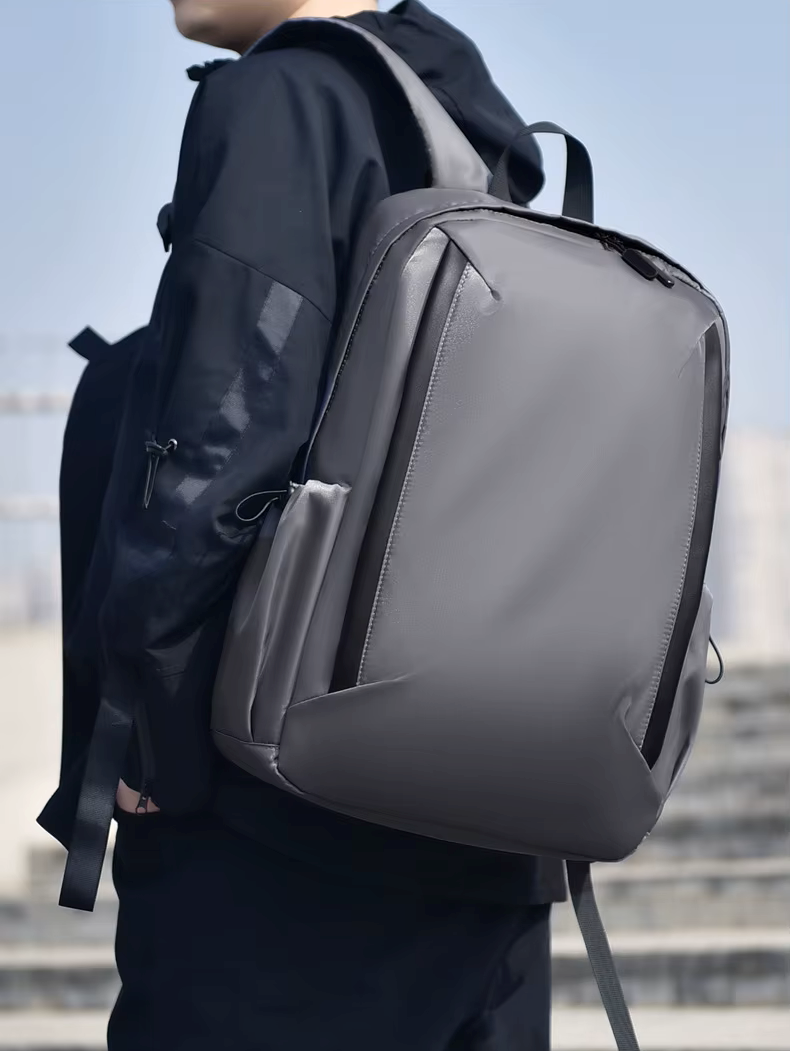 Person wearing a gray backpack with a blurred background